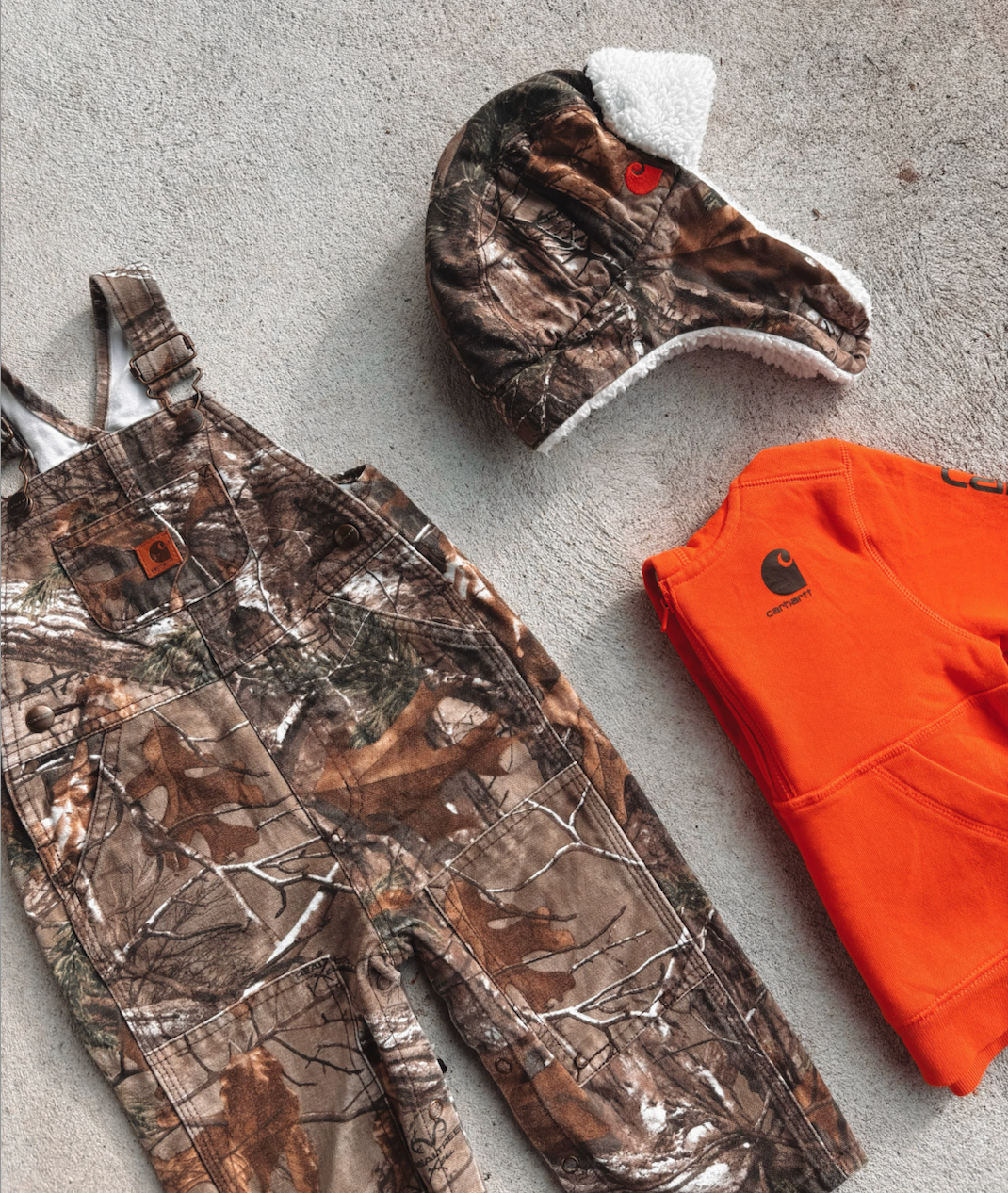 Carhartt overalls and hat in real tree and orange jersey